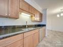 Kitchen features light wood cabinets and granite countertops at 1300 Queens Rd # 303, Charlotte, NC 28207