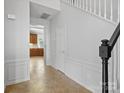 Hallway with tile flooring, white wainscoting, and a view into the kitchen at 151 Paseo Dr, Mooresville, NC 28117