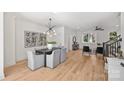 Open concept dining area with hardwood floors and modern light fixture at 2019 Thurmond Pl # 13, Charlotte, NC 28205