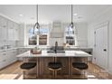 Modern kitchen with island, white cabinets, and stainless steel appliances at 2019 Thurmond Pl # 13, Charlotte, NC 28205