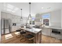 Modern kitchen with island, white cabinets, and stainless steel appliances at 2019 Thurmond Pl # 13, Charlotte, NC 28205