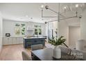 Modern kitchen with island, white cabinets, and stainless steel appliances at 2023 Thurmond Pl # 14, Charlotte, NC 28205