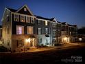 Row of townhomes at night, lit by festive lights at 2133 Tupelo Grove Ln, Gastonia, NC 28054