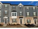 Front exterior of a townhome with gray siding and brick facade at 2133 Tupelo Grove Ln, Gastonia, NC 28054