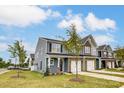 Attractive townhome community featuring multiple homes with gray siding and stone accents at 6288 Culbert St # 191, Harrisburg, NC 28075