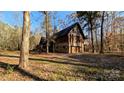 Log cabin home with stone accents and a two-car garage at 633 Weston Acres Rd, Fort Lawn, SC 29714