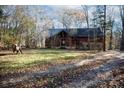 Stunning log cabin home with a spacious front yard and wooded backdrop at 633 Weston Acres Rd, Fort Lawn, SC 29714