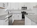 Modern kitchen with granite countertops, stainless steel appliances, and white shaker cabinets at 920 Sycamore Ave, Gastonia, NC 28052