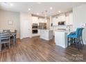 Open kitchen with white cabinets, stainless steel appliances, and an island at 2513 Bullfrog Ln, Lancaster, SC 29720