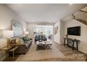 Open living room with hardwood floors, a neutral color palette and modern furniture at 8108 Downy Oak Ln, Charlotte, NC 28269