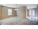 Bright dining area with neutral carpeting and chandelier at 9315 Ames Hollow Rd, Charlotte, NC 28216