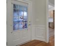 Bright entryway with a white door featuring a floral glass insert and hardwood floors at 1012 Sweetleaf Dr, Fort Mill, SC 29707