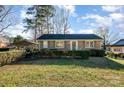 Brick ranch house with carport and neat landscaping at 2809 Markland Dr, Charlotte, NC 28208