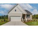 Modern house exterior with beige siding and a two-car garage at 168 Wylie Trl, Statesville, NC 28677