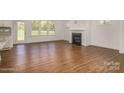 Living room with hardwood floors, fireplace, and access to backyard at 168 Wylie Trl, Statesville, NC 28677