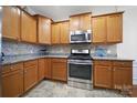 Modern kitchen with stainless steel appliances and wood cabinets at 2011 Vermount Way, Fort Mill, SC 29707