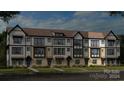 Modern three-story townhome community with landscaped yards at 207 Tamala St, Davidson, NC 28036