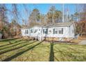 Inviting single-story home with a front porch and landscaped yard under the shade of trees at 3433 Spinner Ct, Sherrills Ford, NC 28673