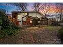 Brick patio with pergola, screened porch, and firepit at 6108 Netherwood Dr, Charlotte, NC 28210