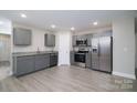 Modern kitchen featuring stainless steel appliances, gray cabinets, and granite countertops at 1014 Kansas St, Kannapolis, NC 28083
