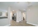 Open concept kitchen and living area with stainless steel appliances and wood-look flooring at 1014 Kansas St, Kannapolis, NC 28083