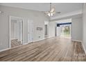 Spacious living room with wood-look flooring, ceiling fan, and doorways leading to other areas of the home at 1344 Pampas Cir, Rock Hill, SC 29732