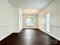 Formal dining room with dark hardwood floors, chandelier, and white walls at 1364 Lloyd Nw Pl, Concord, NC 28027