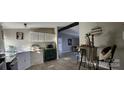 Charming kitchen with white cabinets, stainless steel appliances, and farmhouse decor at 3431 Polkville Rd, Shelby, NC 28150