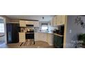 Bright kitchen with white cabinets and modern appliances at 3431 Polkville Rd, Shelby, NC 28150