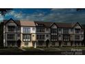 Three-story townhome building with traditional style and landscaping at 5015 Westmead Ln, Charlotte, NC 28262