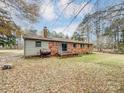 Brick house back view with deck, storage tank, and large yard at 313 Lake Montonia Rd, Kings Mountain, NC 28086
