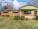 Brick ranch house with covered porch, landscaping, and a spacious yard at 313 Lake Montonia Rd, Kings Mountain, NC 28086