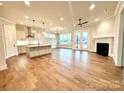 Open concept kitchen and living area with hardwood floors and island at 2971 Alveston Nw Dr # 29, Concord, NC 28027