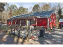 Red house with a metal roof and gated yard at 1115 Marys Grove Church Rd # 1, Kings Mountain, NC 28086
