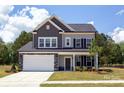 Two-story home with gray siding, stone accents, and a two-car garage at 169 Wylie Trl, Statesville, NC 28677