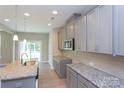 Modern kitchen with gray cabinets, granite countertops, and stainless steel appliances at 169 Wylie Trl, Statesville, NC 28677