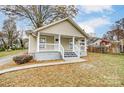 Renovated home with covered front porch, inviting walkway, and fenced backyard at 423 S Oak St, Gastonia, NC 28054