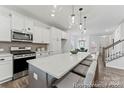 Bright kitchen features white cabinets, stainless steel appliances, and an island at 121 Stonewater Dr # 21, Red Cross, NC 28129