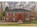 Brick house with red door, shutters, and landscaping at 1426 Green Circle Dr, Gastonia, NC 28054