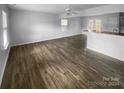 Open living room featuring hardwood floors and a kitchen island at 4438 Cochran Farm Ln, Charlotte, NC 28269