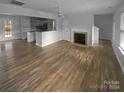 Living room with hardwood floors, fireplace and kitchen views at 4438 Cochran Farm Ln, Charlotte, NC 28269