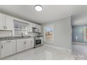 Renovated kitchen with white cabinets and stainless steel appliances at 6423 Cherrycrest Ln, Charlotte, NC 28217