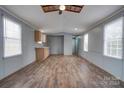 Open living area with wood-look floors, gray walls, and kitchen at 2124 Mcbrayer Springs Rd, Shelby, NC 28150