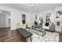 Bright living room with stylish furniture, large windows, and wood floors at 304 Gold Hill Ave, Rockwell, NC 28138