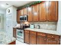 Kitchen with wood cabinets, granite counters, and stainless steel appliances at 417 Stowe Rd, Belmont, NC 28012