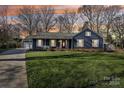 Ranch home exterior at dusk with a well-manicured lawn at 11724 Cricketfield Ct, Charlotte, NC 28277