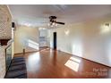 Living room with hardwood floors, fireplace and built-in bench at 236 Sidesmur Ne Ct, Concord, NC 28025