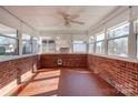 Bright sunroom with brick walls and terracotta tile floor at 236 Sidesmur Ne Ct, Concord, NC 28025