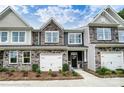 Two-story townhome with stone and shingle exterior, two-car garage at 4107 Black Ct # 166, Harrisburg, NC 28075