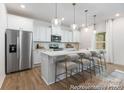 Modern kitchen with white cabinets, a large island, and stainless steel appliances at 1108 Alyssa Oaks Dr # 3, Lowell, NC 28098